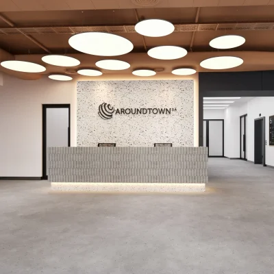 Frontalansicht der Rezeption in einem Berliner Bürogebäude mit Zugang zu den Aufzügen und moderner Gestaltung.