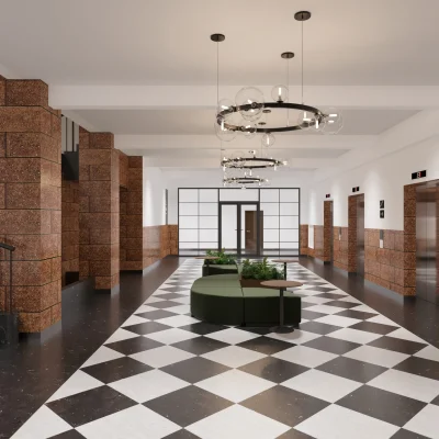 Die moderne und helle Lobby des Werkhauses in Berlin mit Aufzügen und Treppenaufgang.