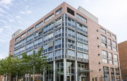 Straßenansicht des Bürogebäudes Volta Eins in Frankfurt mit markanter Architektur, großzügigem Eingangsbereich und urbanem Umfeld.