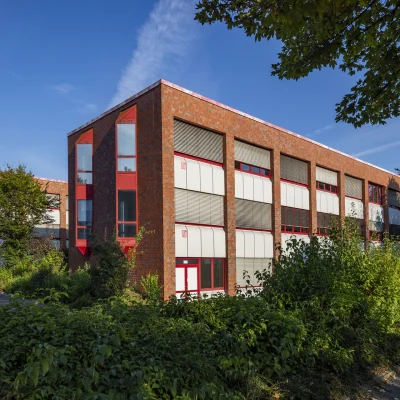 Außenansicht des Büroensembles am Alten Hellweg 56–60 in Dortmund mit mehreren Gebäudeteilen, begrünten Außenflächen und klar strukturierter Architektur.