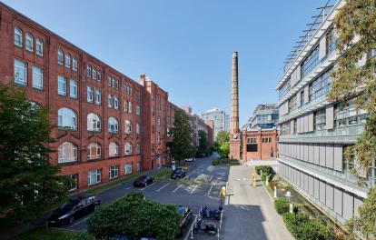 Außenansicht der Erlenhöfe Berlin mit denkmalgeschützter Backsteinarchitektur und modernen Bürogebäuden in urbanem Umfeld.