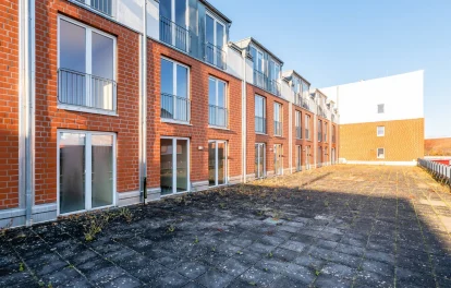 Backsteinfassade des Gebäudekomplexes mit Dachterrasse in Perspektive