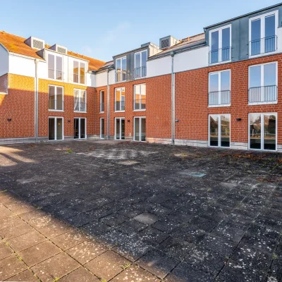 Backstein-Innenhof mit Dachterrasse und Balkonen des Wohnkomplexes